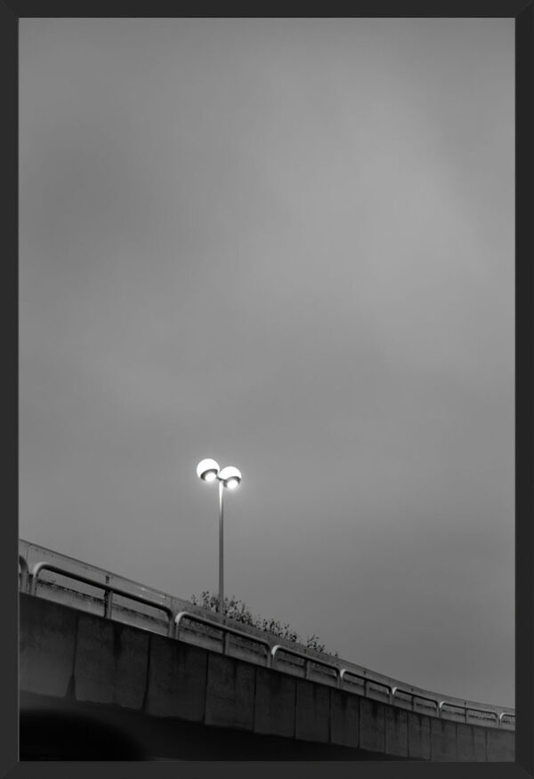 Minimalist photograph of light on a bridge.
