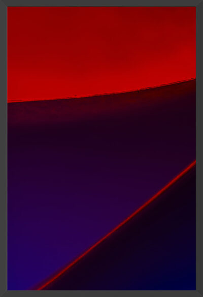 Edges of paper under blue and red lights.