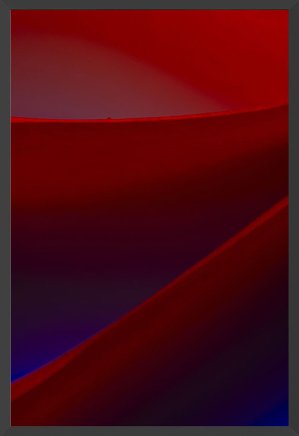 Edges of paper under blue and red lights.