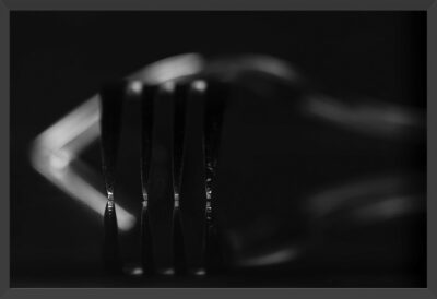 Abstract micro capture of forks and reflections in black and white.