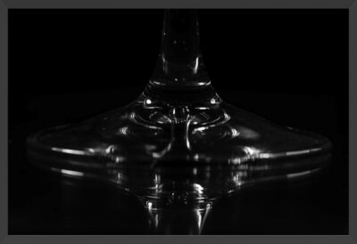 Abstract capture of a wine glass base and reflection.