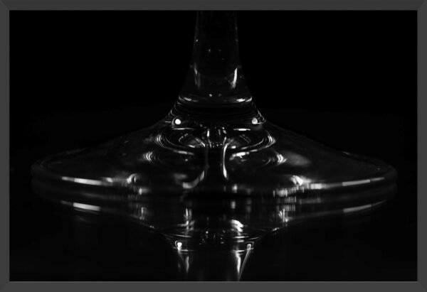 Abstract capture of a wine glass base and reflection.